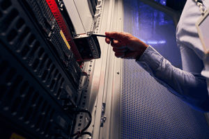 experienced-data-center-it-technician-installing-resized (1)