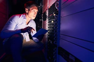 focused-caucasian-system-administrator-monitoring-1200x800